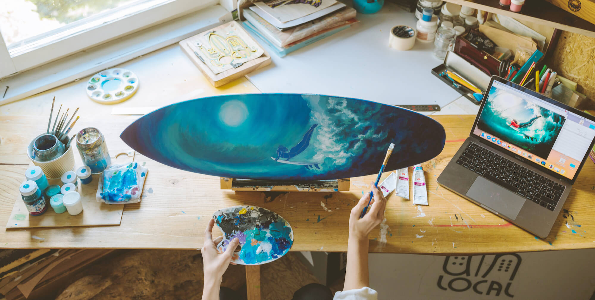A surf art painting on miniature surfboard