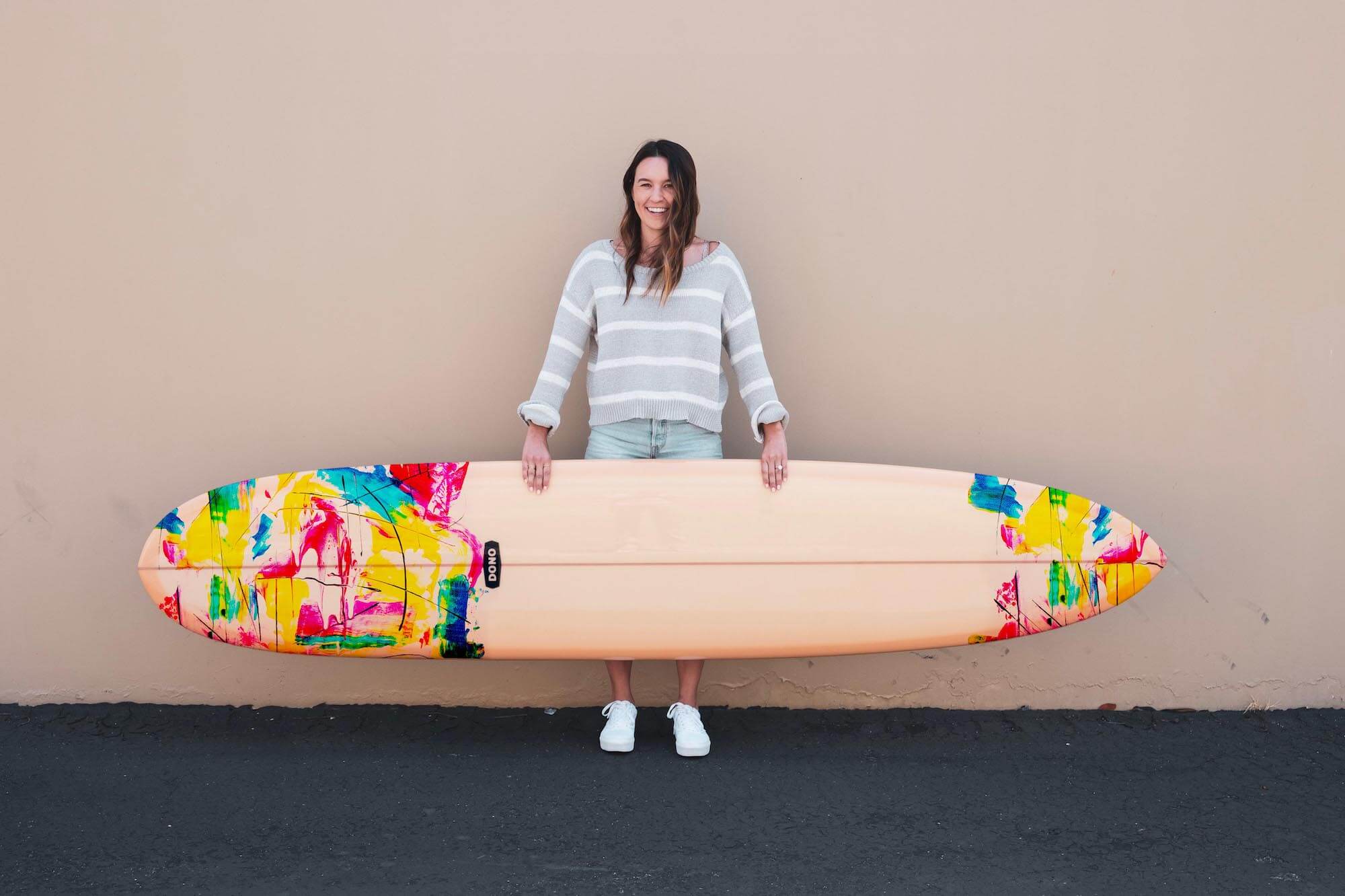 woman holding abstract Hawaii surfboard art 