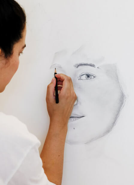 JT Ojerio of Aloha de Mele sketching a portrait in her Honolulu studio