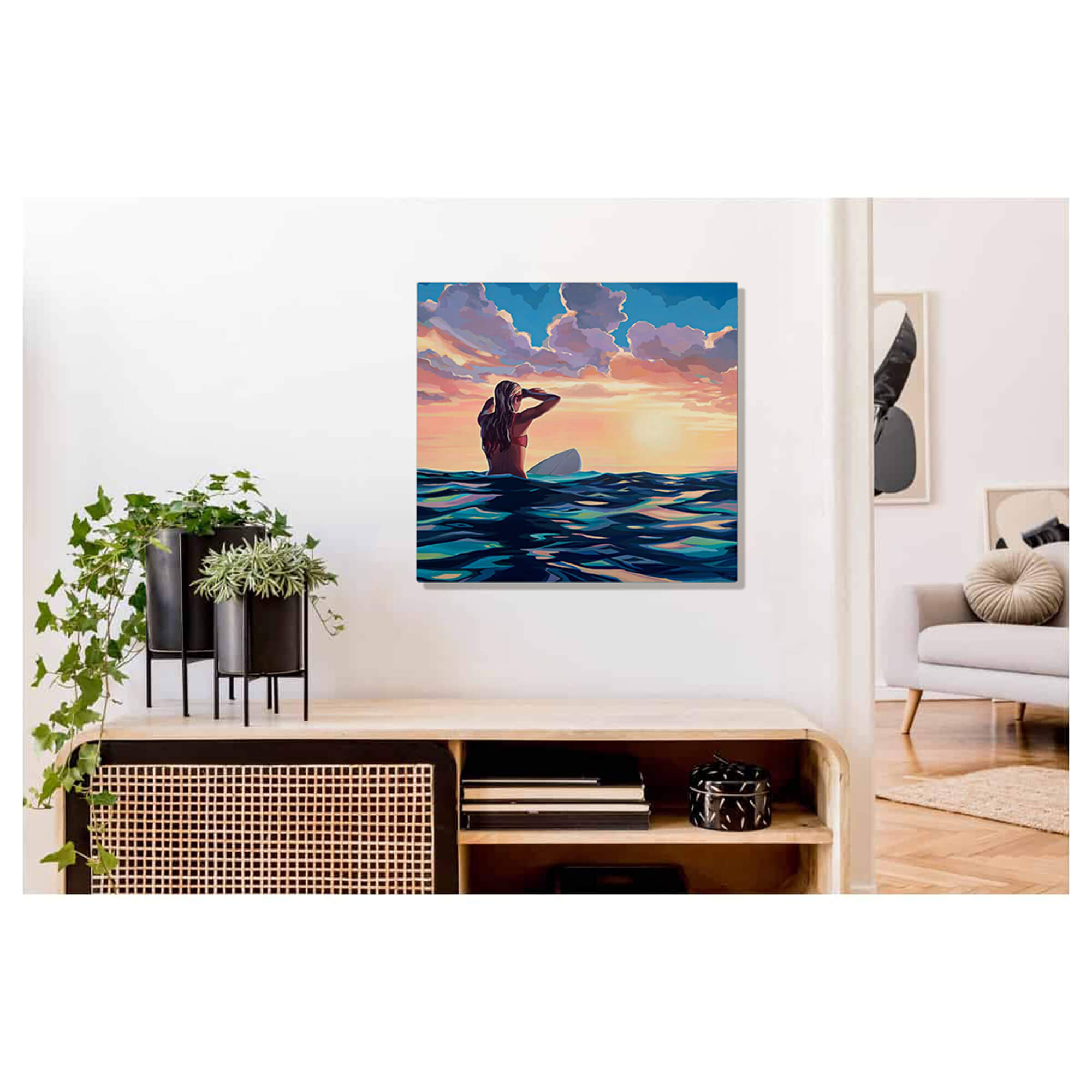 Metal art print of a woman sitting on her surfboard surrounded by the blues of the ocean looking out onto the sunset by Hawaii artist Christie Shinn