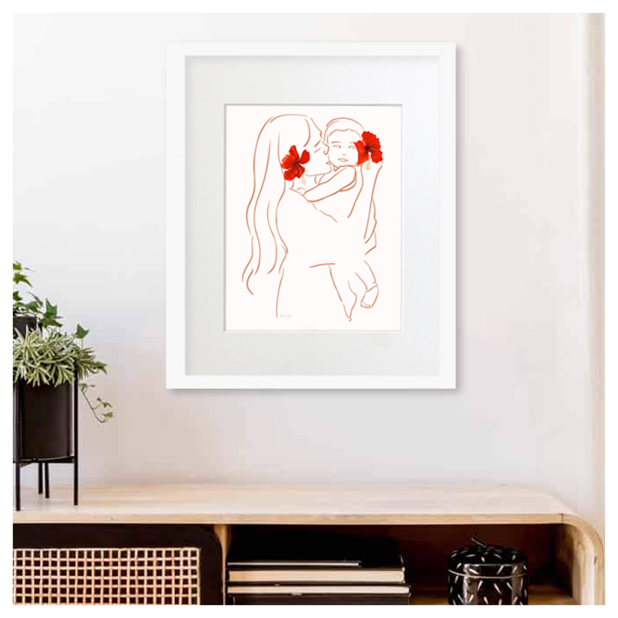 A framed matted art print of Matted art print featuring a mother holding her baby with vibrant red hibiscus flowers by Hawaii artist Aloha De Mele