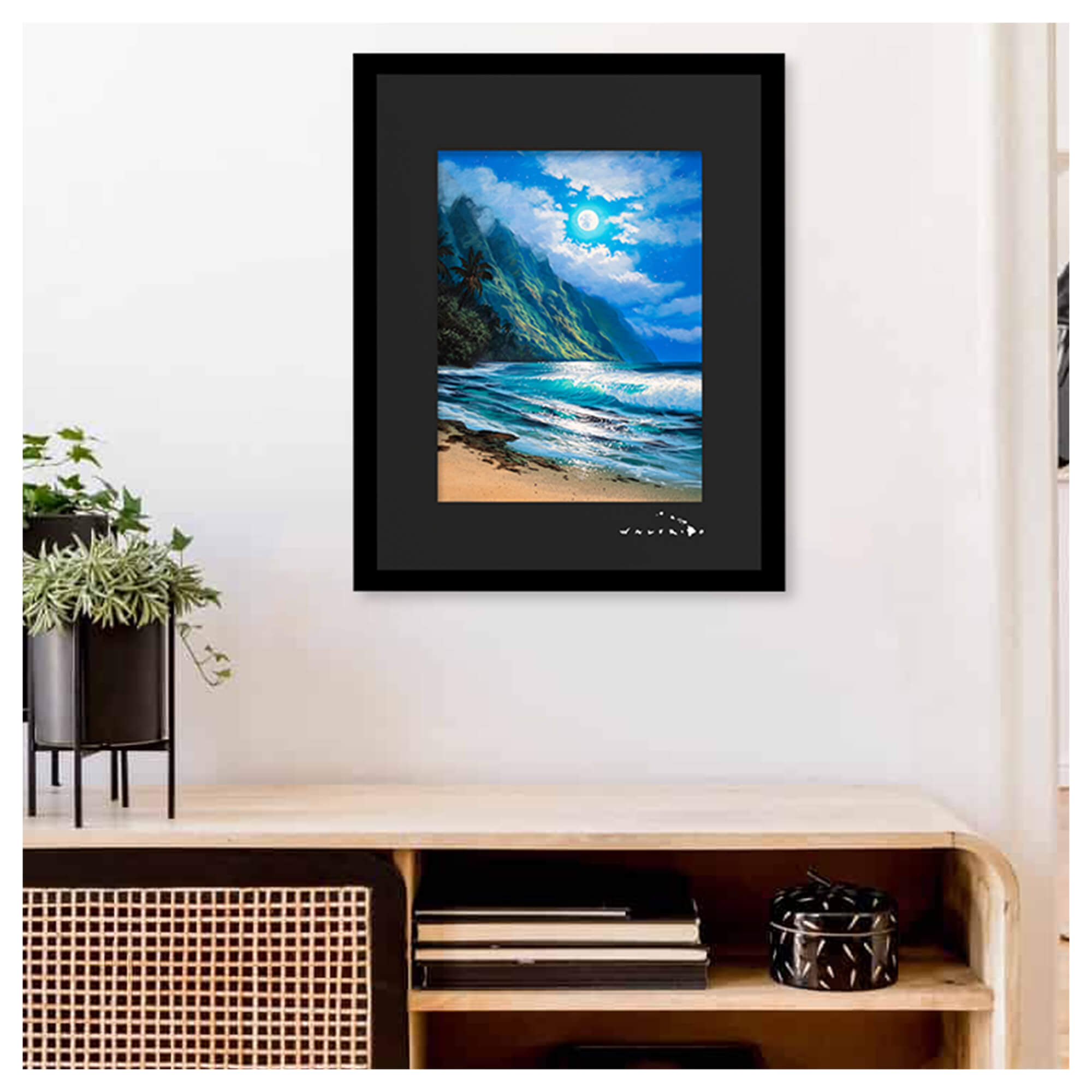 A framed matted art print depicting a moonlit seascape surrounded by dramatic mountains by Hawaii artist Walfrido Garcia